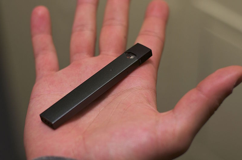 A Juul, a common vaping device, is small enough to fit into someones hand.

Image from Wikimedia Commons
