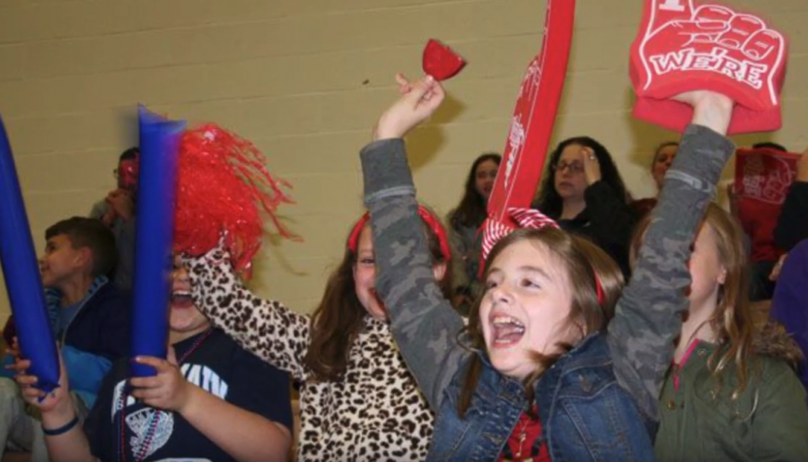 Students cheer on their favorite team during the annual St. Judes game