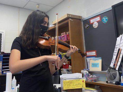 Anastasia Mamkin practicing her violin minutes before her High School All-County audition.