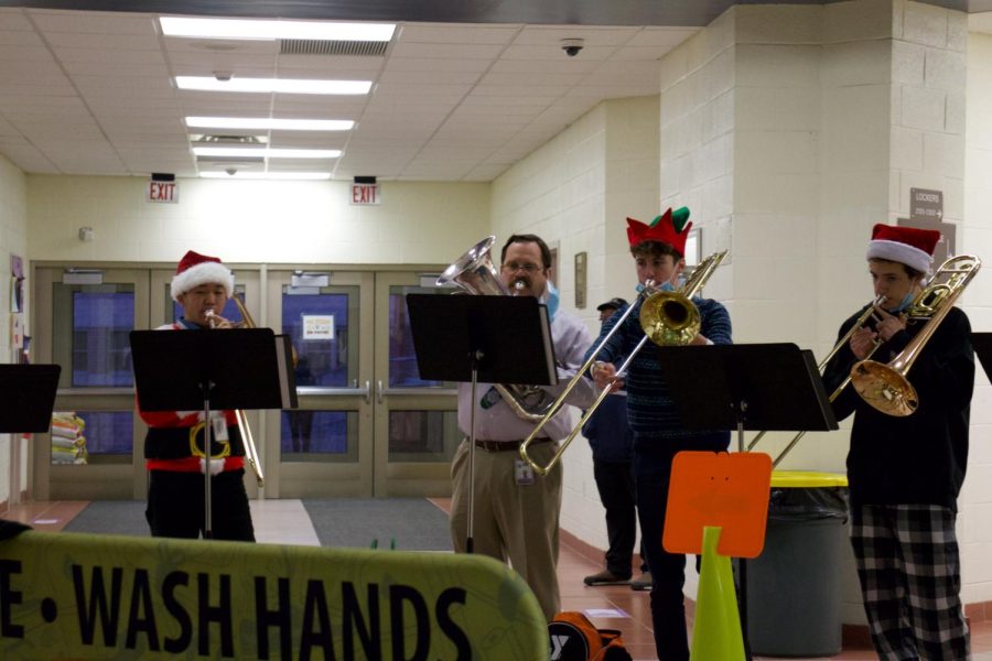 Mr.+Kaste+plays+his+euphonium+and+accompanies+student+musicians+while+they+play+holiday+songs