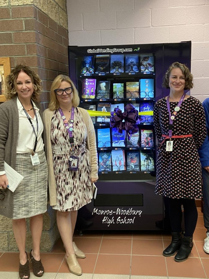 English Department Chairperson Ms. Bulla and librarians Ms. Sherman and Ms. Speer stand in front of the new book vending machine outside the main office on A floor.