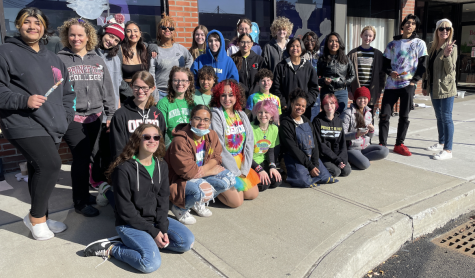 Art Honor Society Students gather for a picture outside the local businesses. 