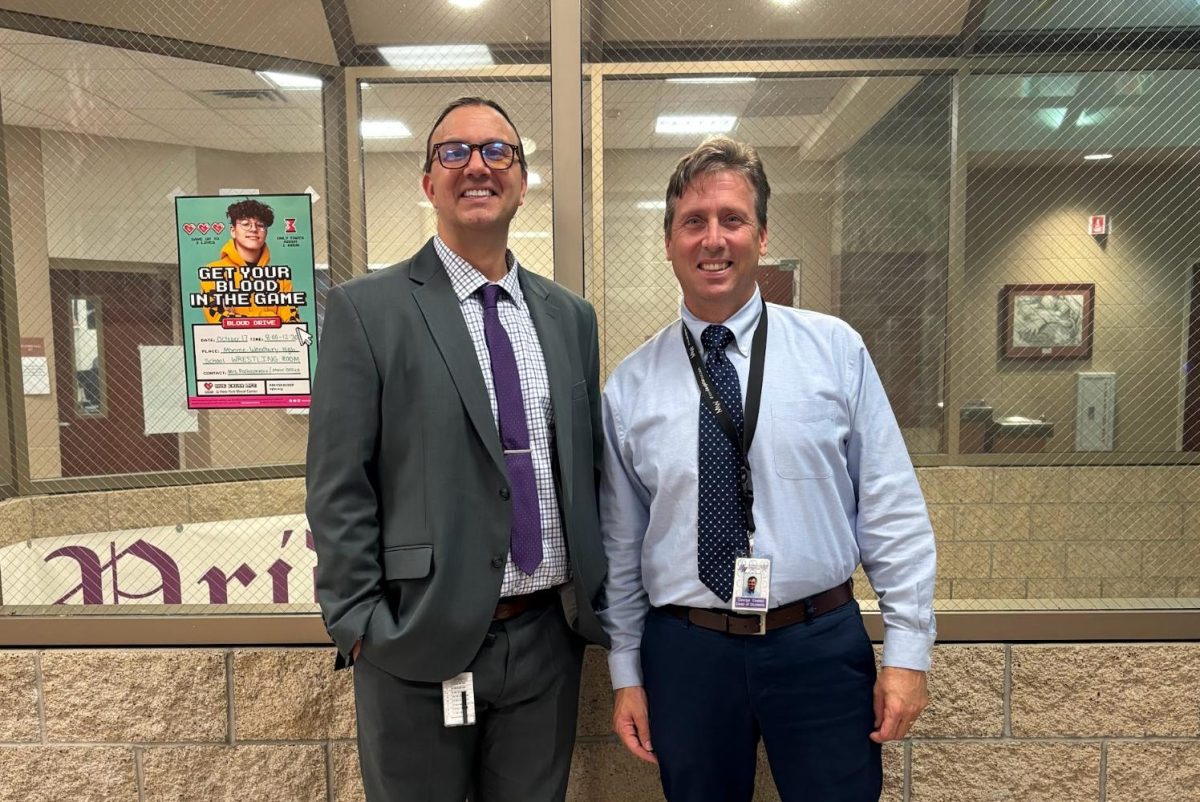 Interim Principal Mr. McElroy, left, poses next to Interim Dean of Students Mr. Coates.