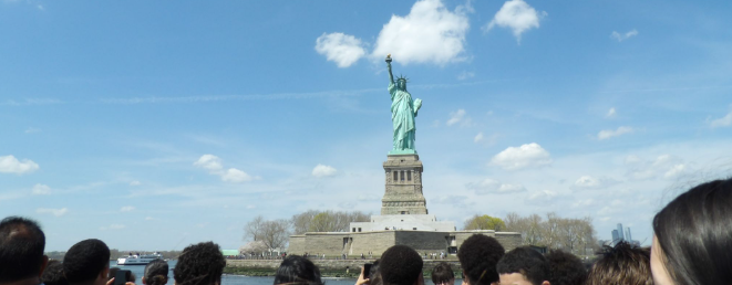 Students look out at the Statue of Liberty from the ferry.