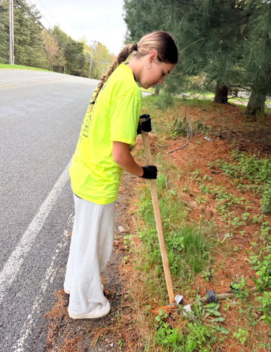 A Monroe-Woodbury student picks up litter during May's Clean Sweep event.
